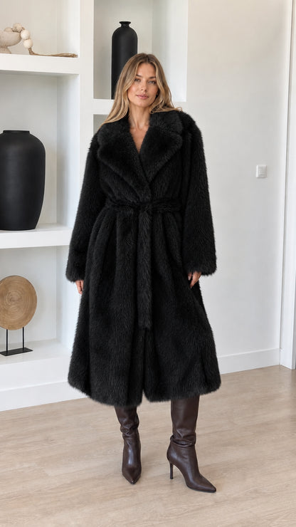 Full-length view of model wearing black plush faux fur belted wrap coat