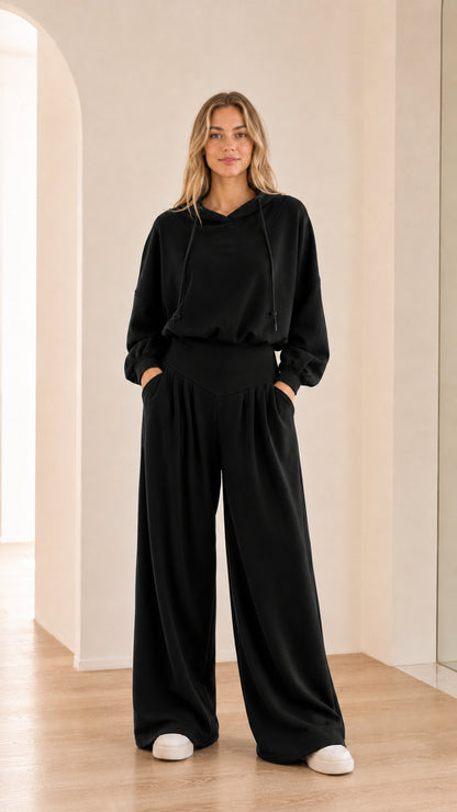 Full-body view of model wearing black 2-piece wide-leg hoodie set