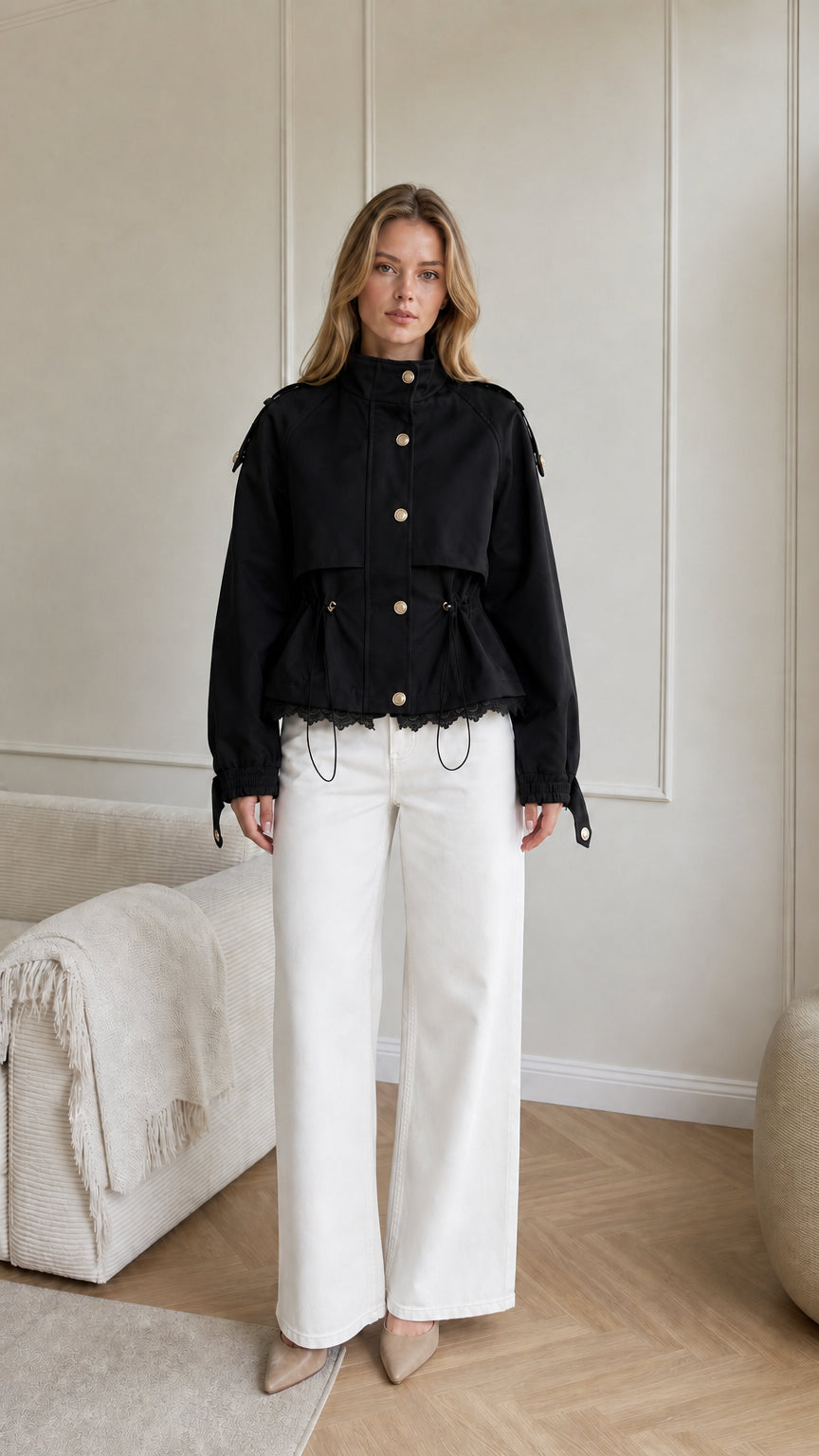 Model wearing black cropped utility jacket with drawstring waist and lace trim
