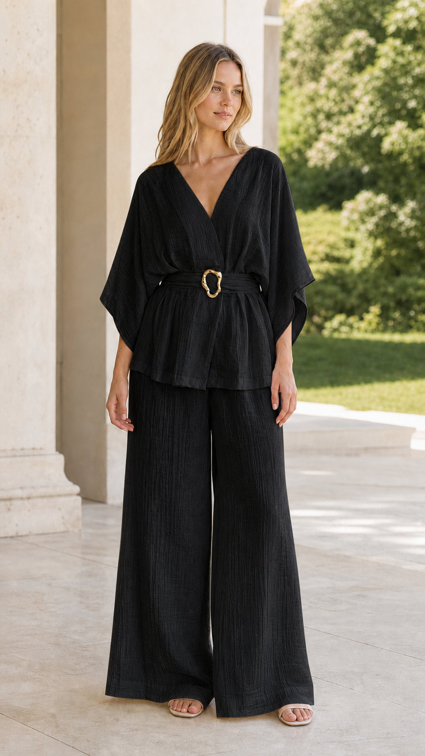 Model wearing black belted kimono top and wide-leg pant set