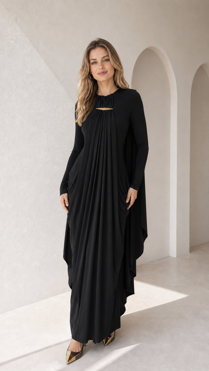 Full-length front view of black pleated long sleeve cape maxi gown