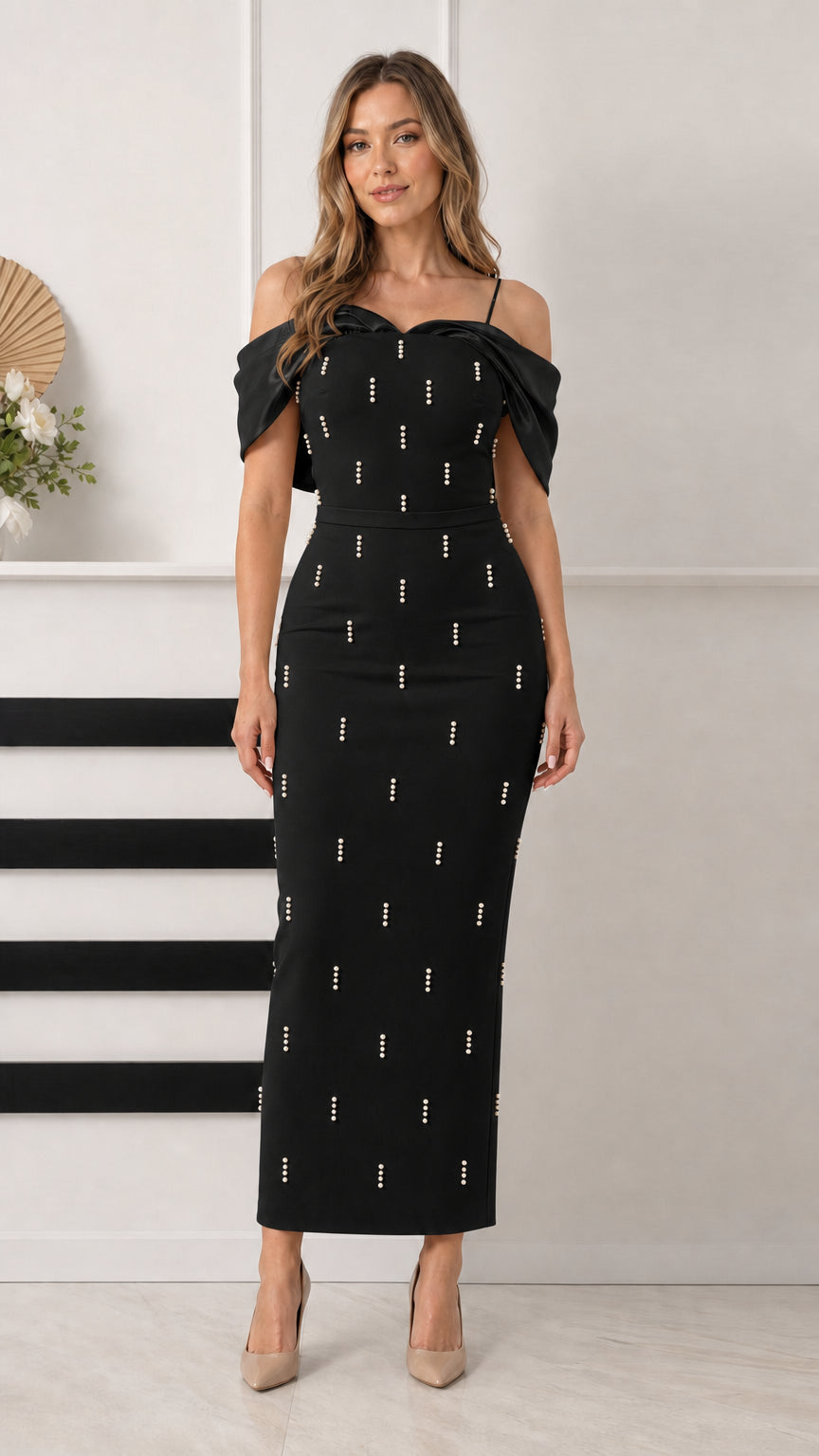 Front view of black pearl-embellished off-the-shoulder column formal dress