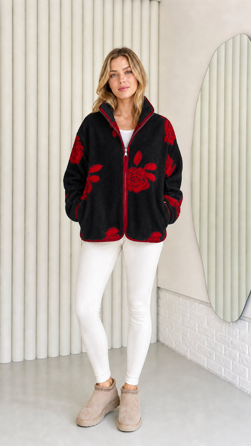 Model wearing black fleece jacket with red floral pattern