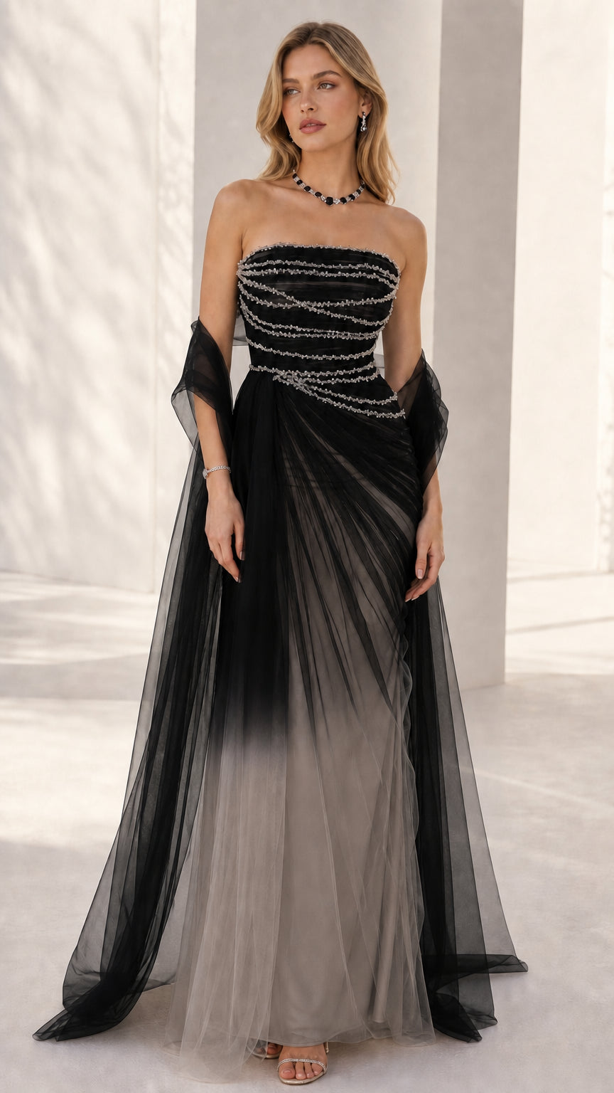 Front view of the strapless beaded evening gown in black to grey ombre tulle
