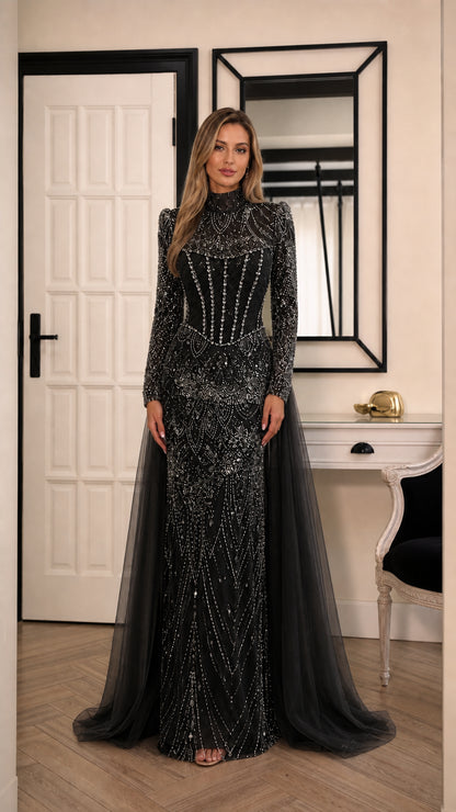 Model wearing black high neck beaded long sleeve evening gown with tulle train