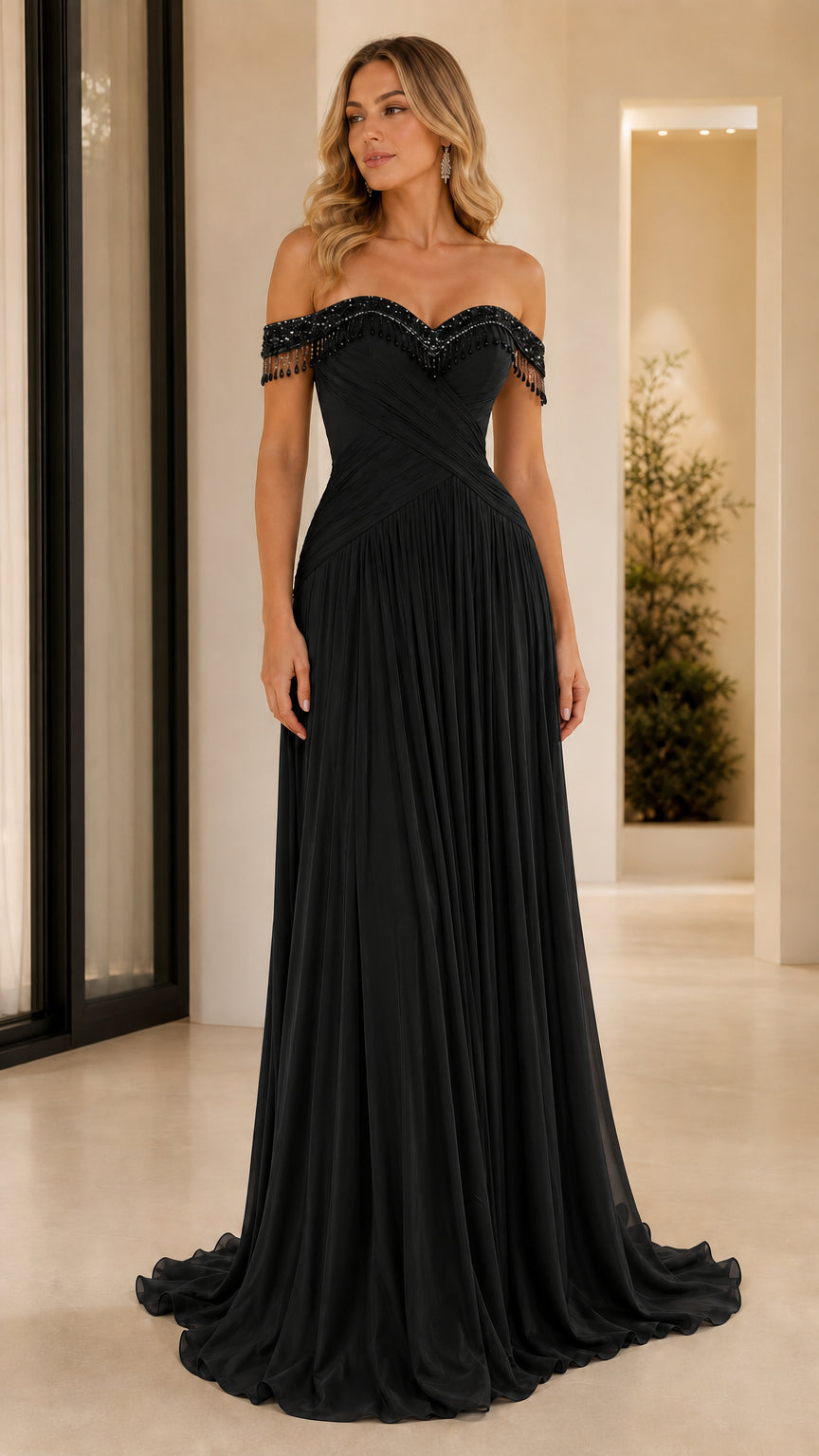 Front view of black off-the-shoulder pleated evening gown with beaded fringe detail
