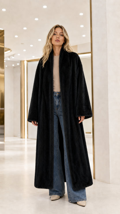 Front view of model wearing the black maxi faux fur overcoat