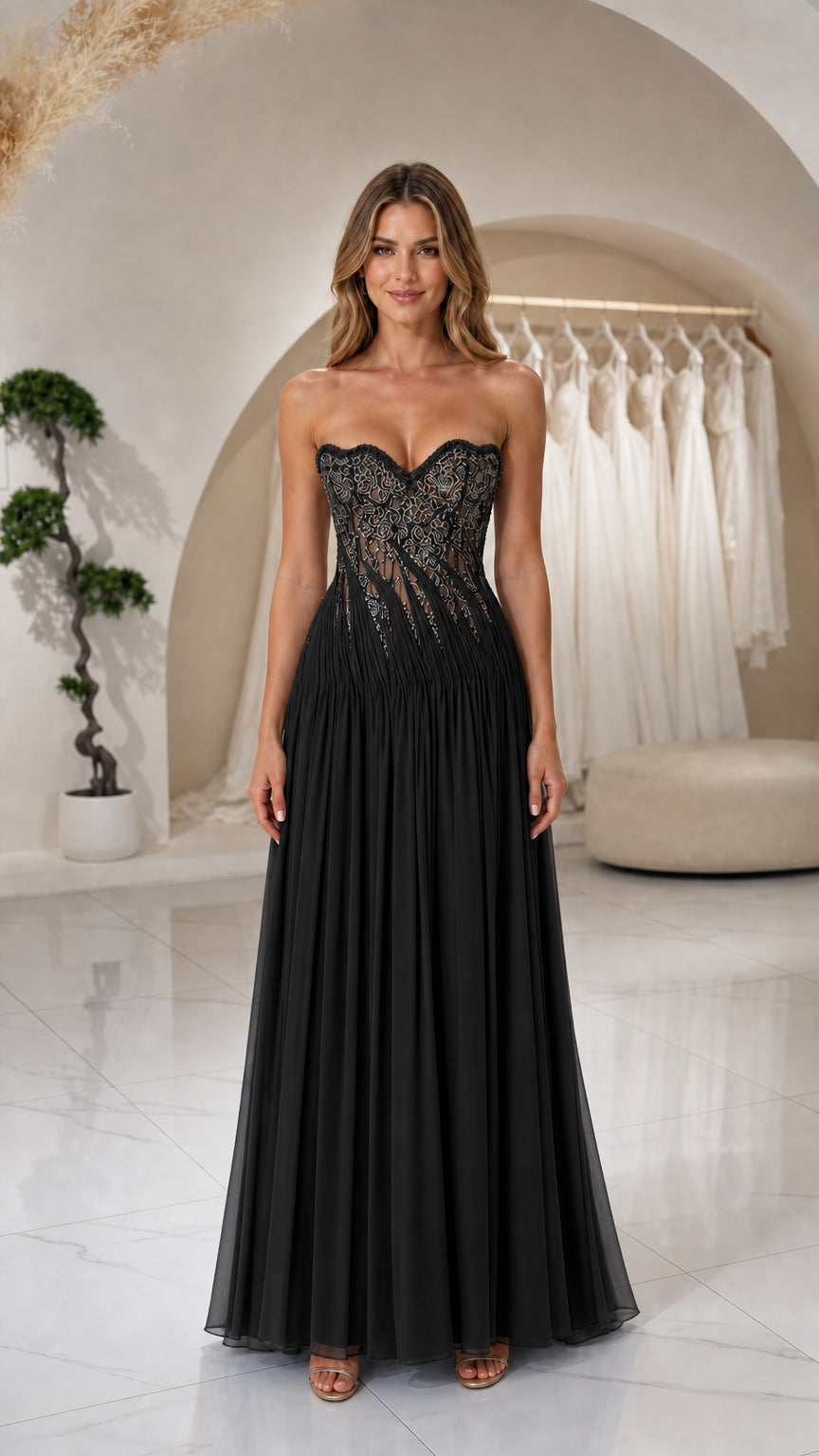 Front view of woman wearing Black strapless beaded corset pleated maxi gown