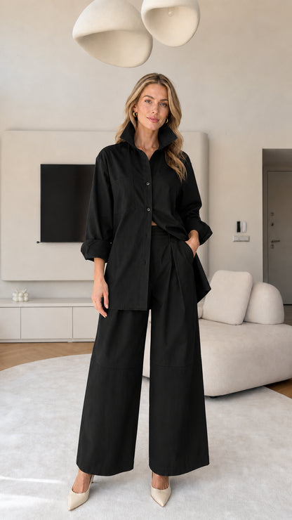 Front view of women's matching button-down shirt and wide-leg trousers set in Black