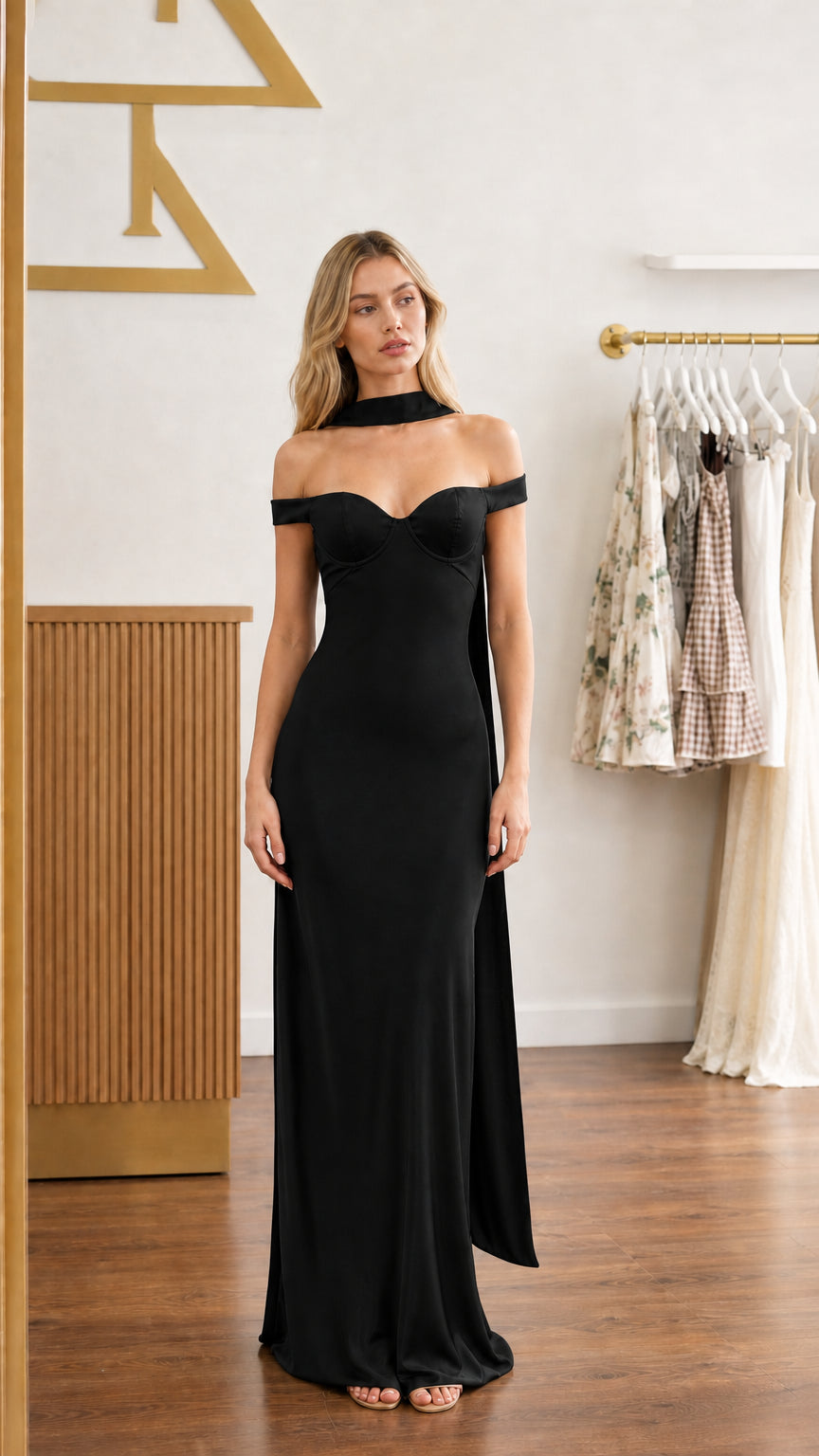 Model wearing black satin off-shoulder bustier maxi dress - front view