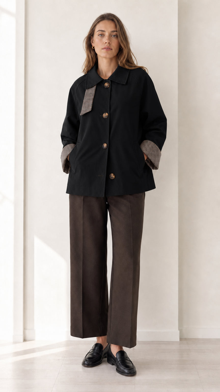 Front view of women's black short trench jacket with houndstooth collar trim