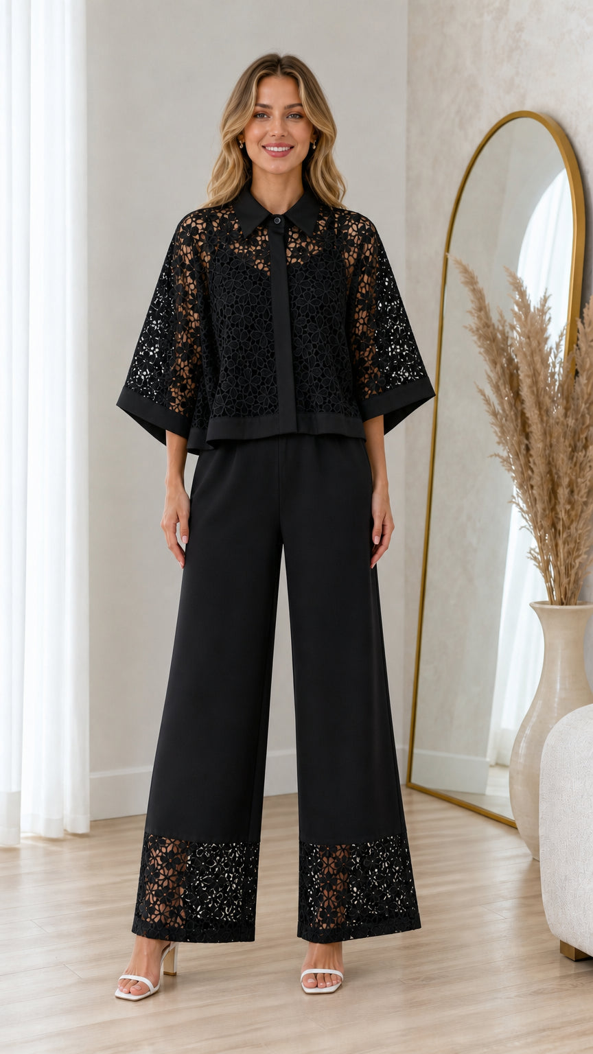 Model wearing black floral lace capelet blouse and wide-leg trousers set