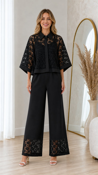 Model wearing black floral lace capelet blouse and wide-leg trousers set