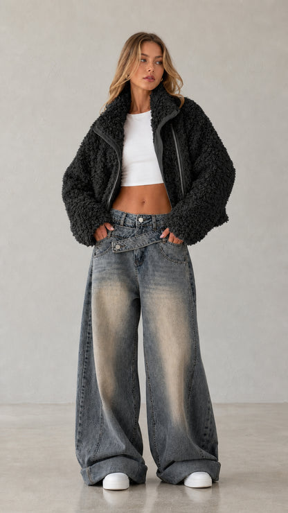 Full body studio shot of woman wearing black cropped teddy fleece jacket