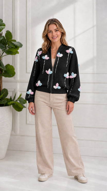 Model wearing black 3D floral zip-up knit bomber cardigan