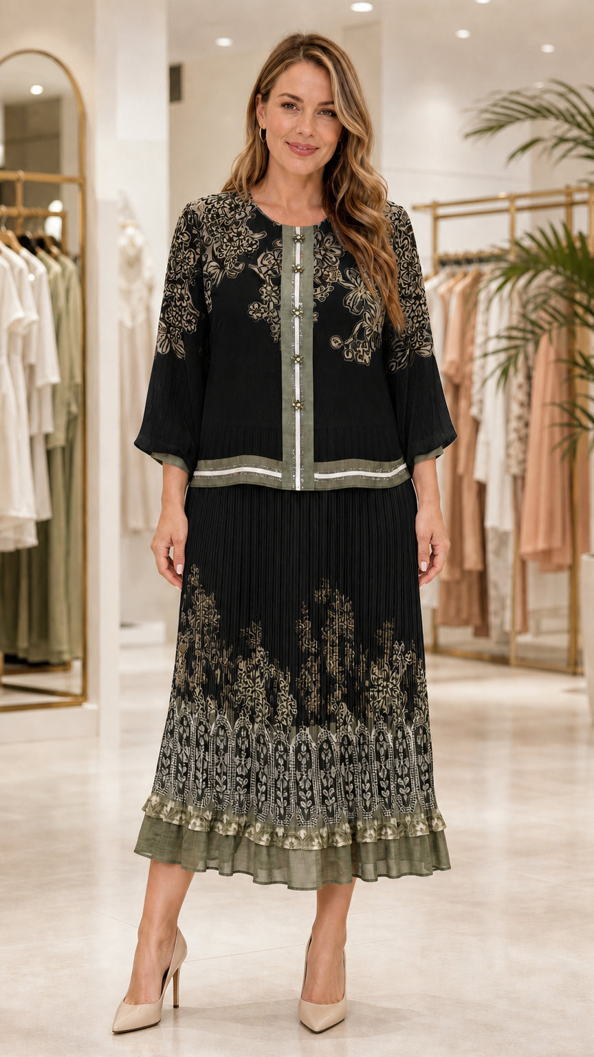 Model wearing black floral print blouse and matching pleated midi skirt set