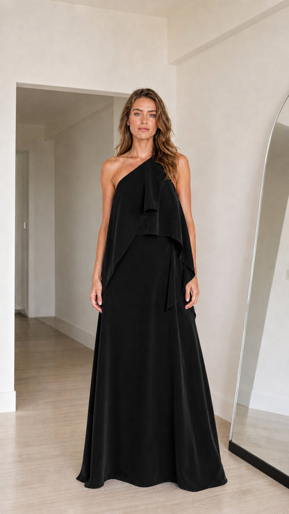 Model wearing black one-shoulder tiered draped evening maxi dress