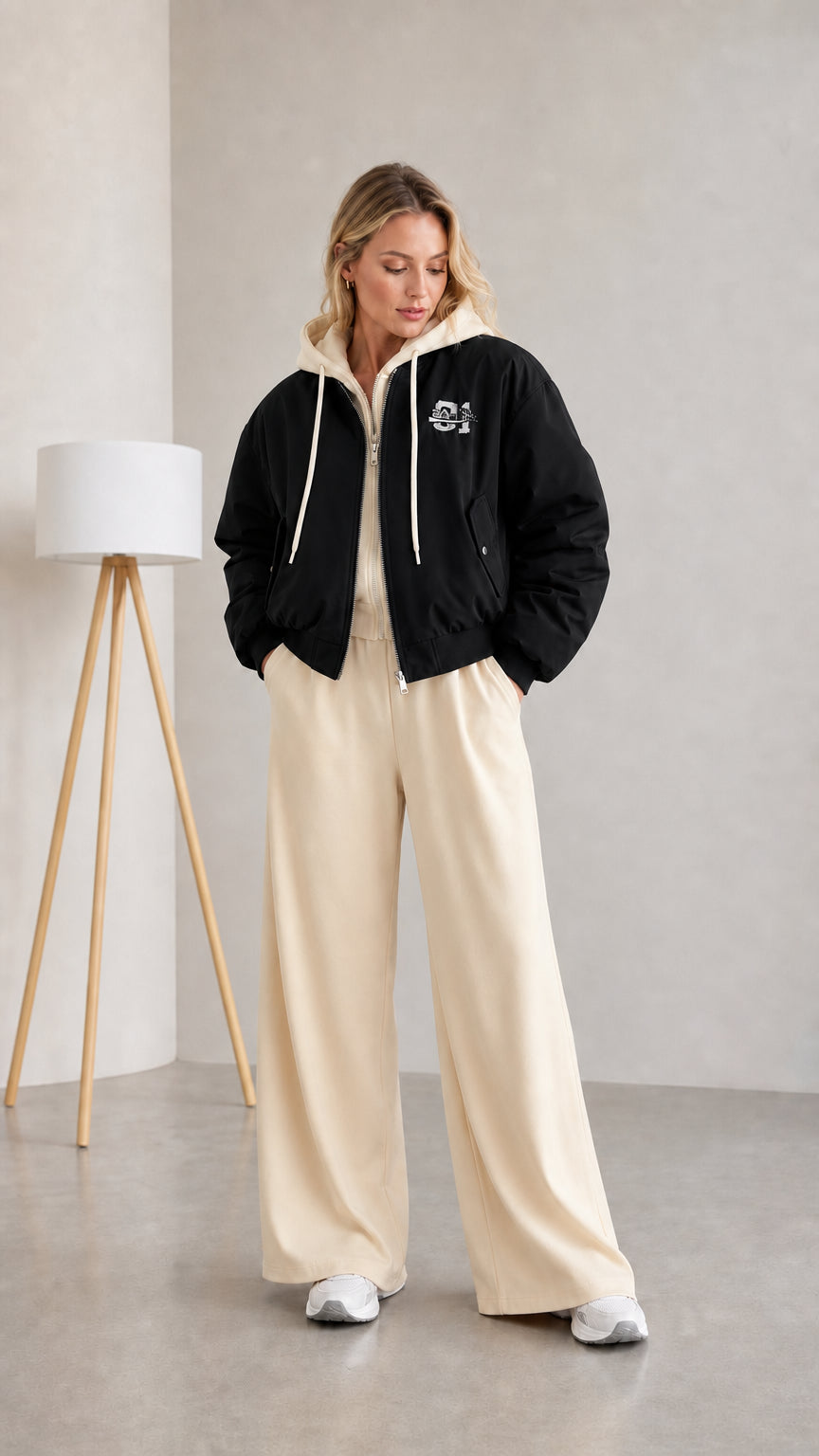 Woman wearing black layered hooded bomber jacket