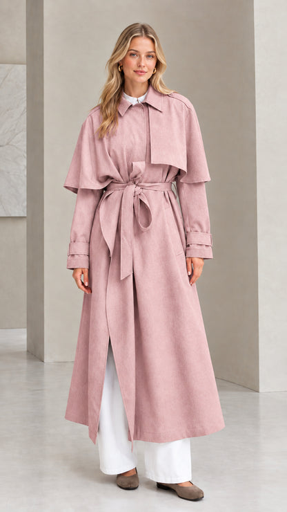 Front view of dusty pink capelet maxi trench coat with tie belt