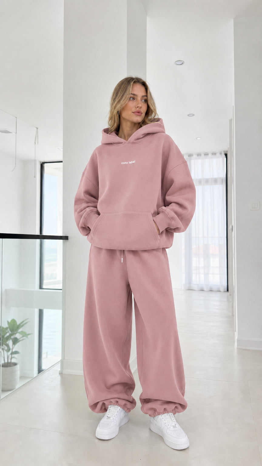Full-length view of model wearing the dusty pink fleece hoodie and sweatpants set