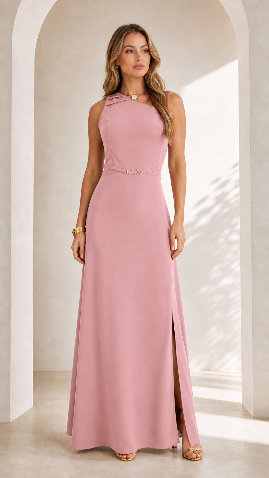 Front full view of woman wearing blush pink sleeveless asymmetrical maxi dress