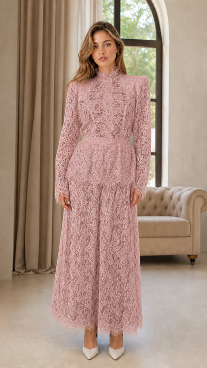 Front full view of woman wearing dusty rose pink lace long sleeve jumpsuit