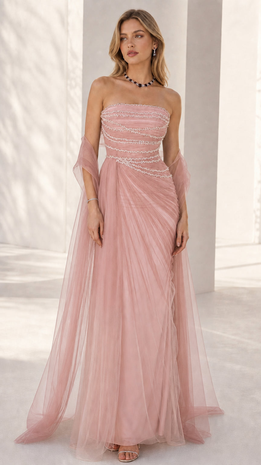 Front view of the strapless beaded formal gown in solid blush pink tulle