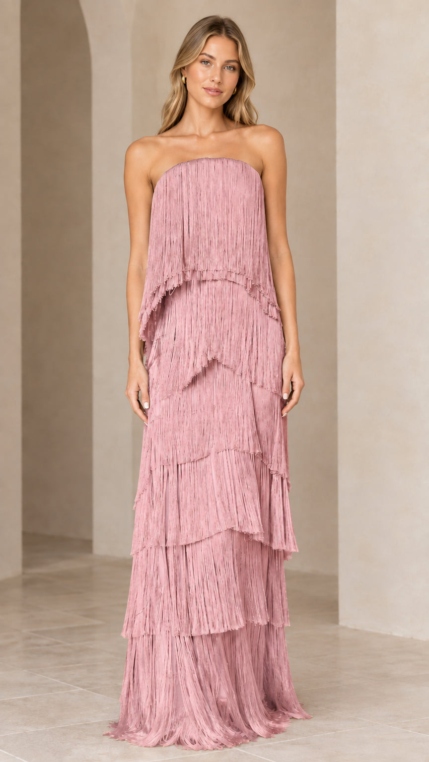 Full-length view of strapless tiered fringe maxi dress in dusty pink