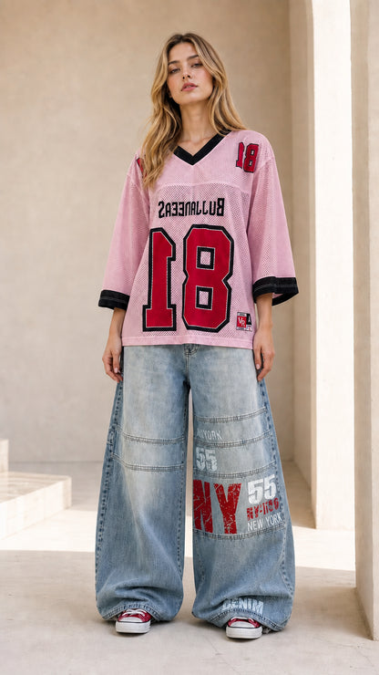 Full front view of light pink oversized sporty mesh graphic jersey top