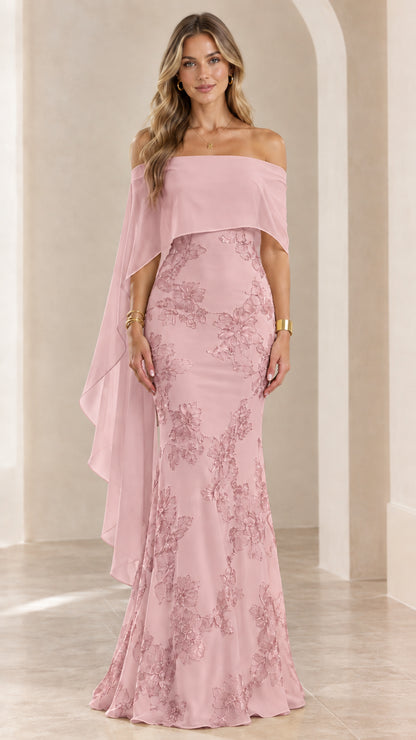 Woman wearing blush pink off-the-shoulder embroidered cape evening gown