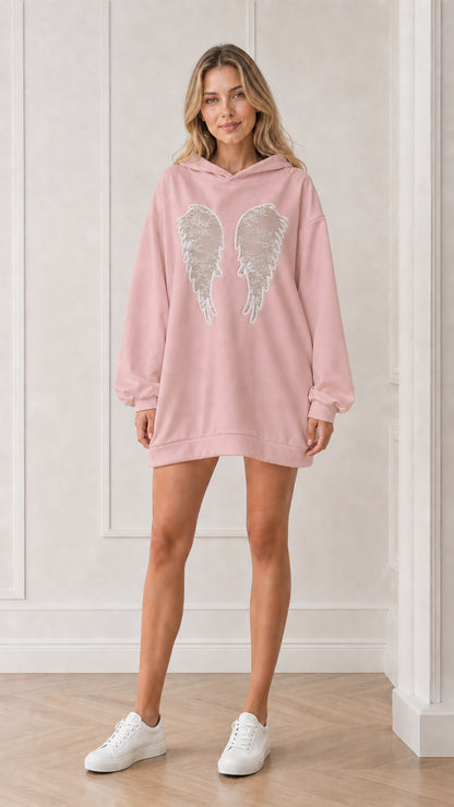 Front view of model wearing the pink oversized angel wings hoodie dress