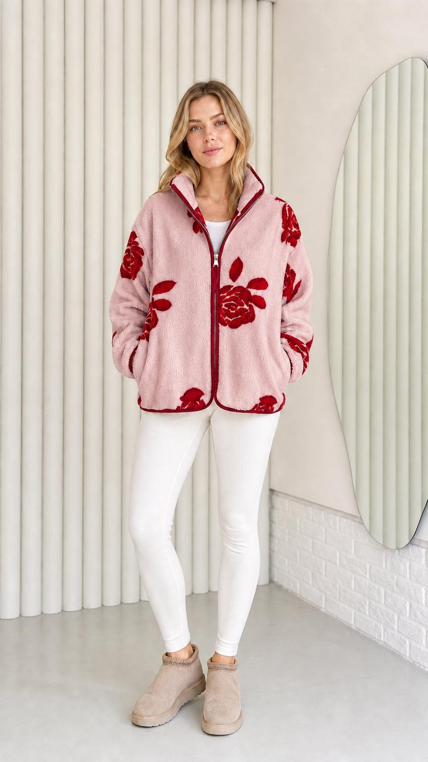 Model wearing dusty pink fleece jacket with red floral pattern
