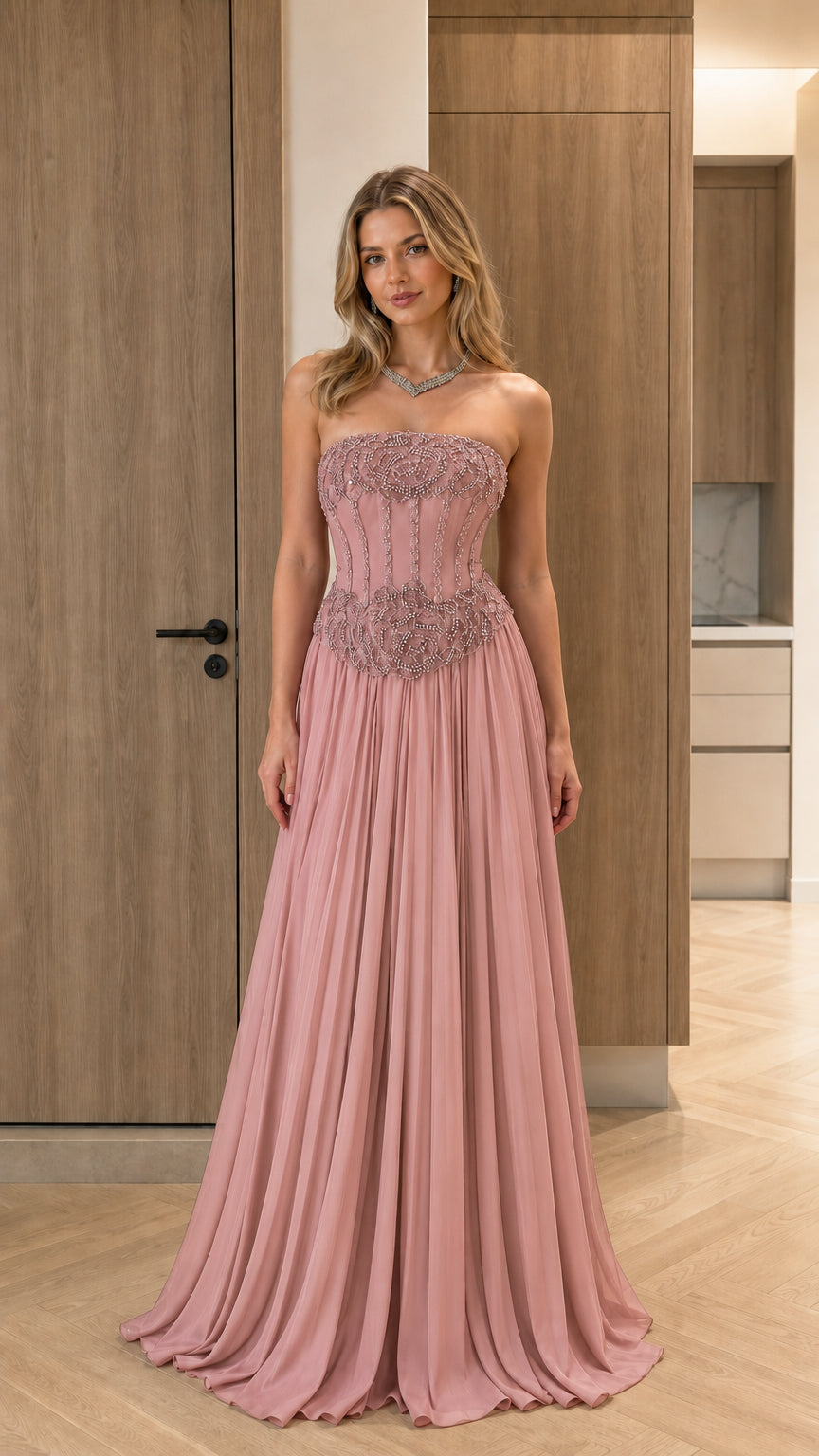 Model wearing dusty pink strapless beaded corset pleated formal gown