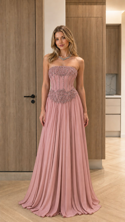 Model wearing dusty pink strapless beaded corset pleated formal gown