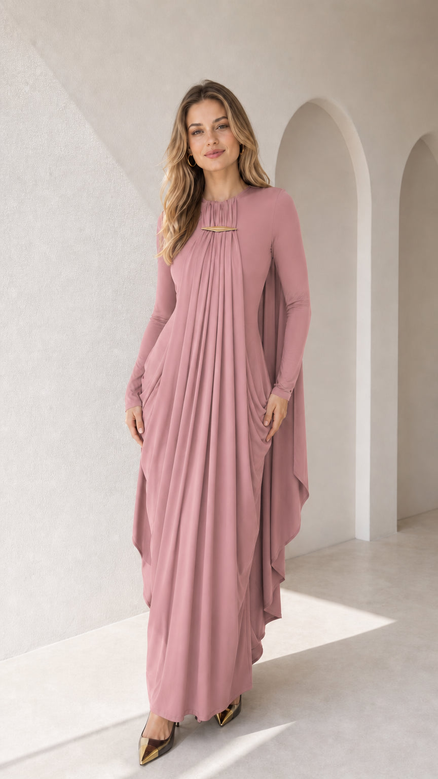 Full-length front view of dusty rose long sleeve pleated cape maxi dress