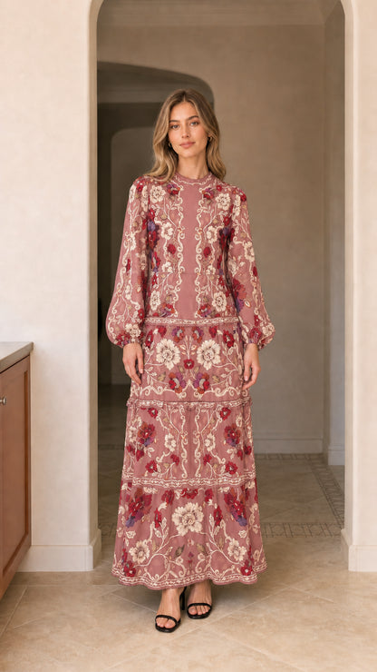 Model wearing long sleeve tiered floral maxi dress in dusty pink