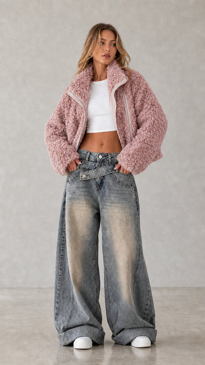 Full body studio shot of woman wearing dusty pink cropped teddy fleece jacket