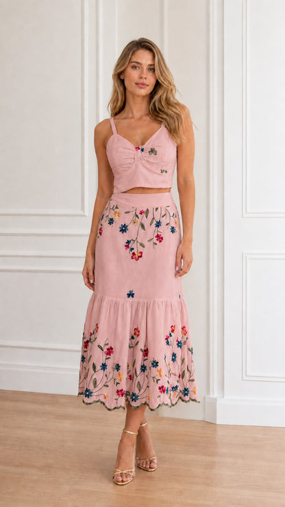 Model wearing dusty pink floral embroidered crop top and tiered midi skirt set