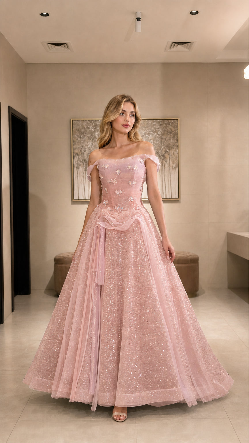 Model wearing blush pink glitter tulle ball gown with off-the-shoulder neckline