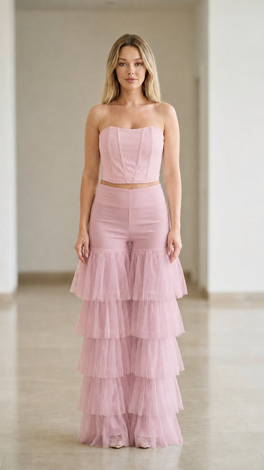 Blush pink strapless corset top paired with tiered tulle ruffle wide-leg pants