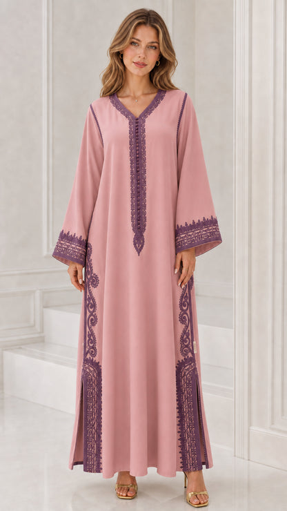 Front full view of woman wearing dusty rose pink kaftan dress with purple embroidery