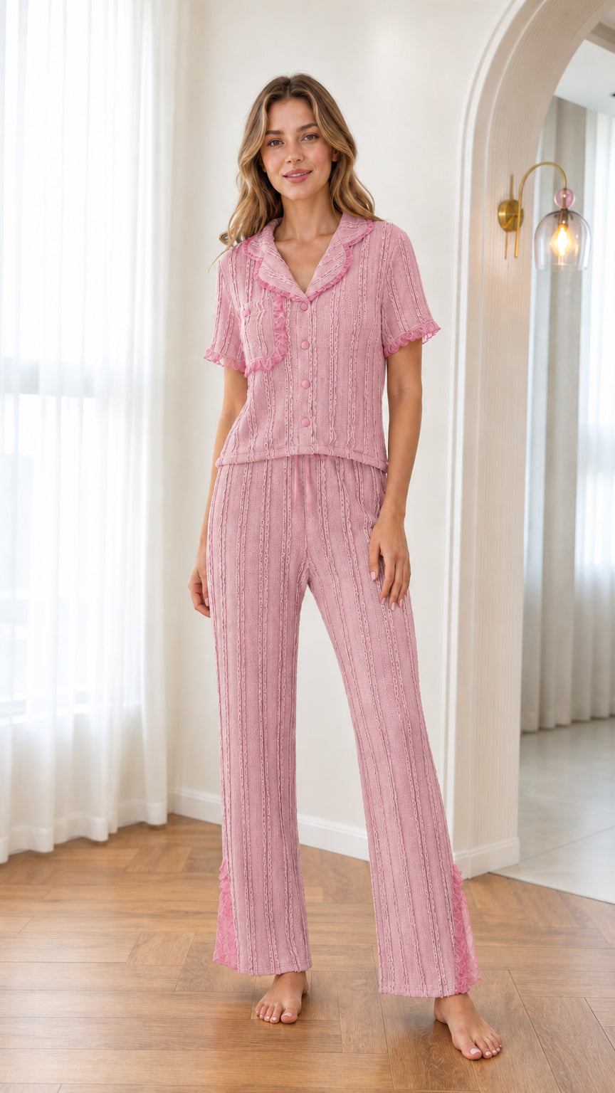Pink knit two-piece pajama set with pink lace ruffle trim on model