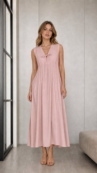 Front view of woman wearing Dusty Pink sleeveless pleated tie-neck midi dress