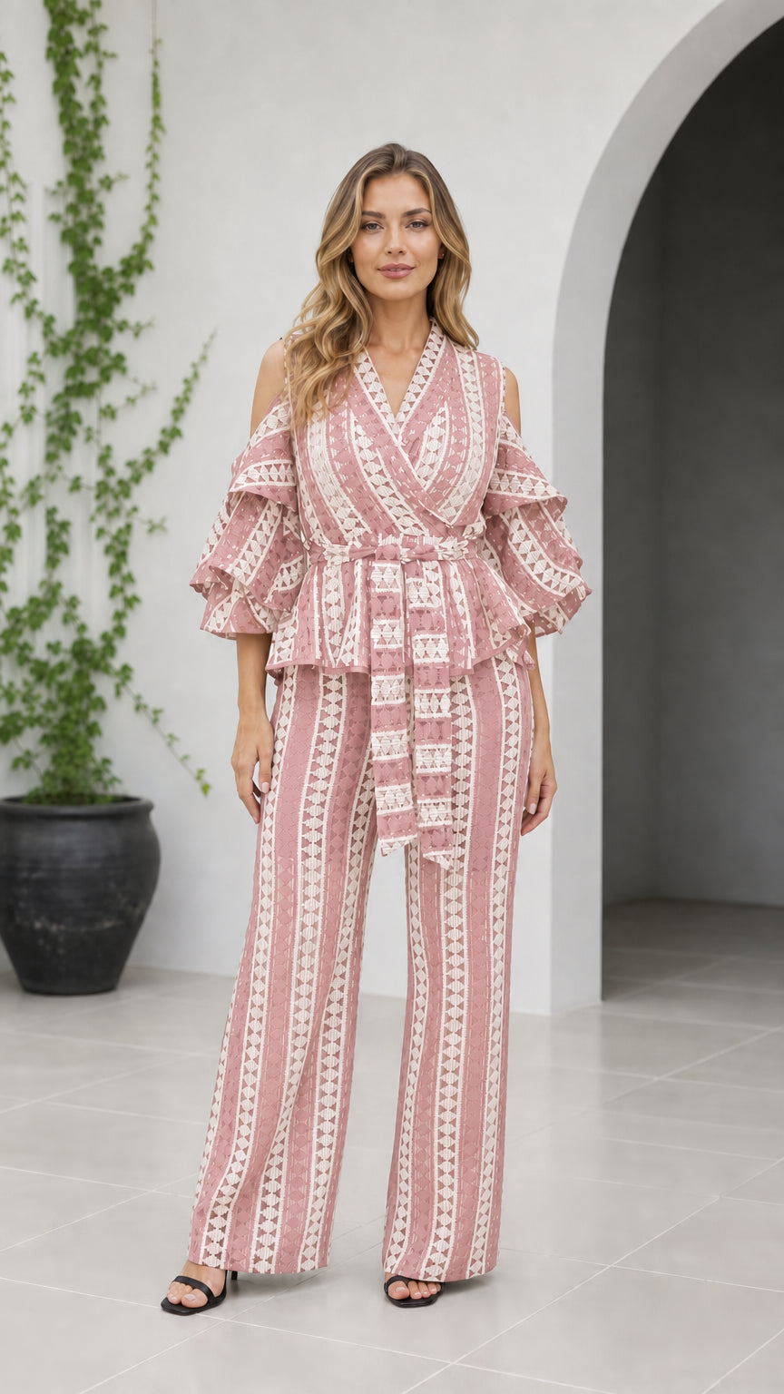 Front view of woman wearing dusty pink geometric cold shoulder wide-leg jumpsuit