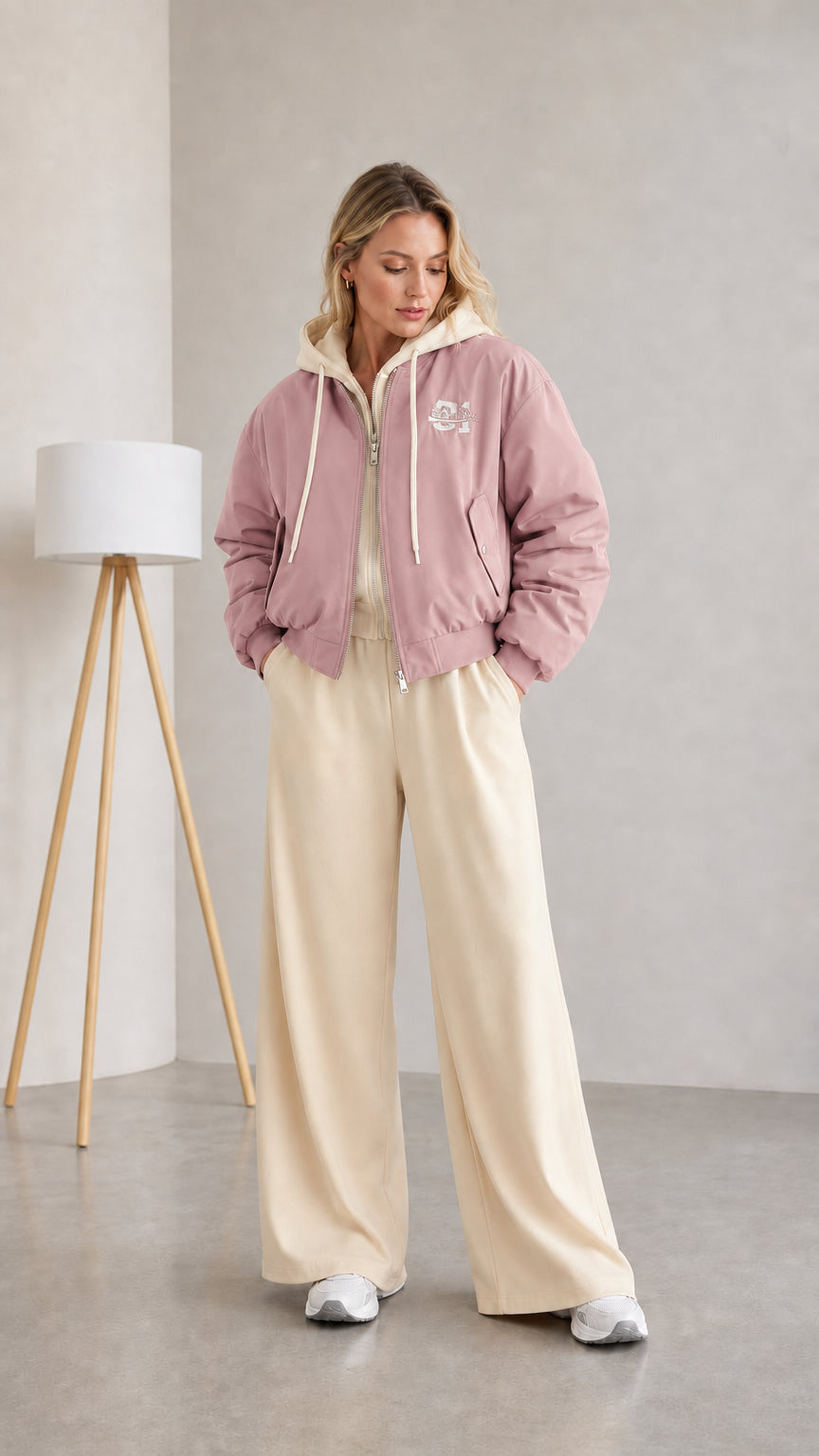 Woman wearing dusty pink layered hooded bomber jacket