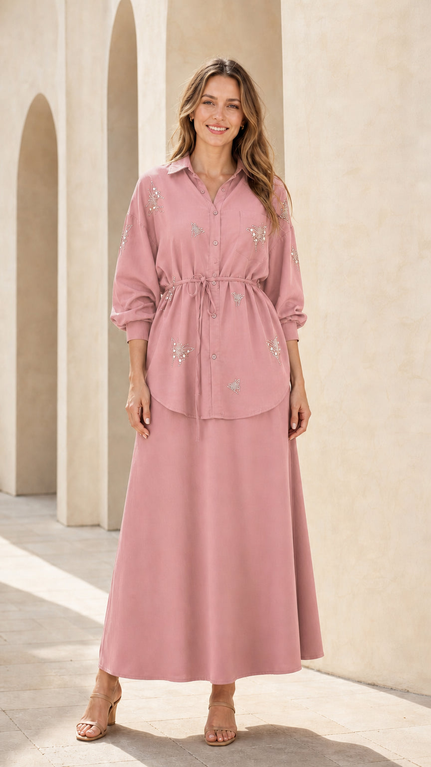 Woman wearing dusty pink embellished button-down tunic top and maxi skirt set