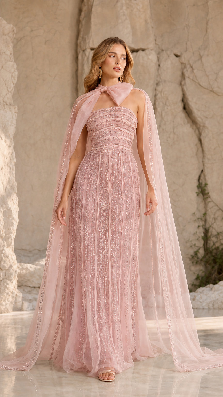Blush pink strapless beaded evening gown with matching sheer bow-neck cape