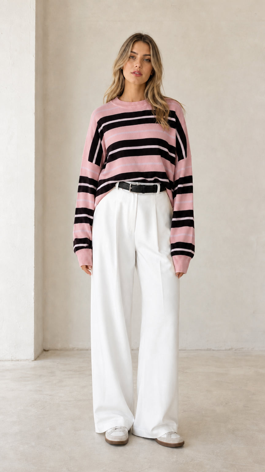 Front view of woman wearing dusty pink striped crewneck pullover sweater
