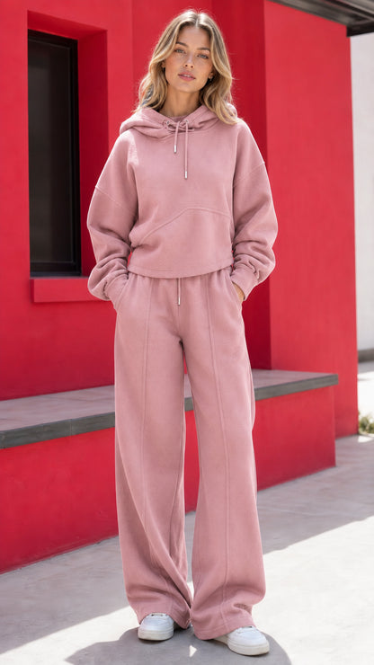 Woman wearing dusty pink two-piece fleece hoodie and wide-leg sweatpants set