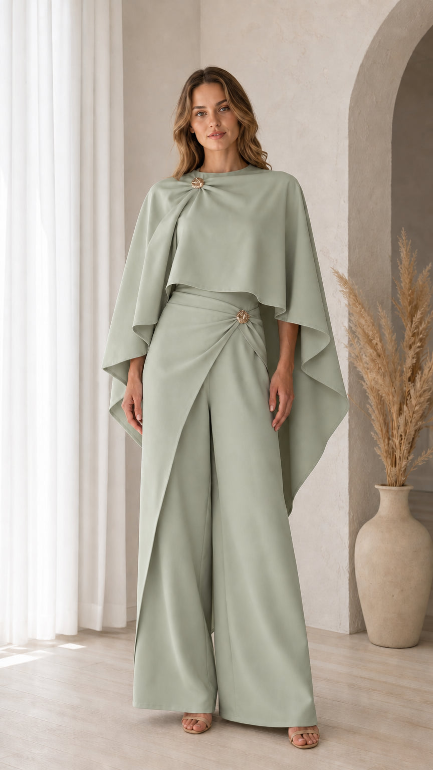Front view of model wearing Sage Green cape overlay top and tailored wide pants